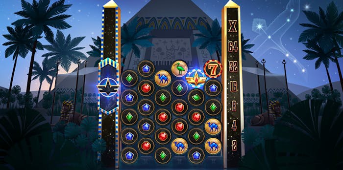 Cygnus pokie game showing cascading reels with circular symbols, including red, blue, and green gems, camels, and multipliers. The game features an Egyptian-themed backdrop with palm trees, obelisks, and a night sky filled with constellations.