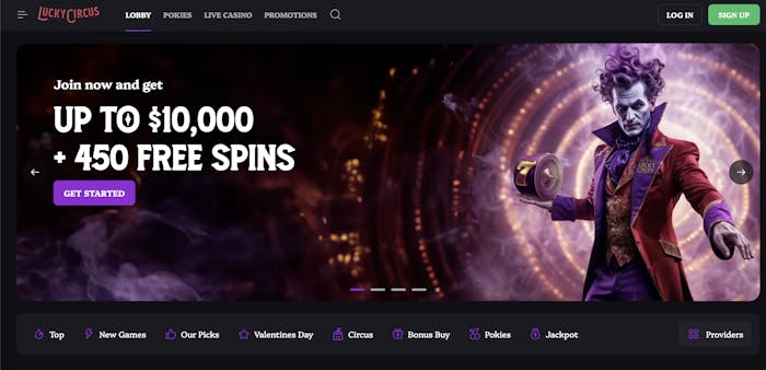 A dark-themed casino homepage featuring a promotional banner offering up to $10,000 and 450 free spins. The central image depicts a mysterious circus-themed character with purple hair, wearing an elegant red and gold suit, holding a roulette wheel.
