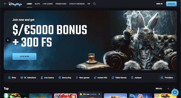 The homepage of PlayMojo Casino featuring a dark theme with a luxury rabbit character wearing sunglasses and a suit. A banner promotes a $/€5000 welcome bonus + 300 free spins