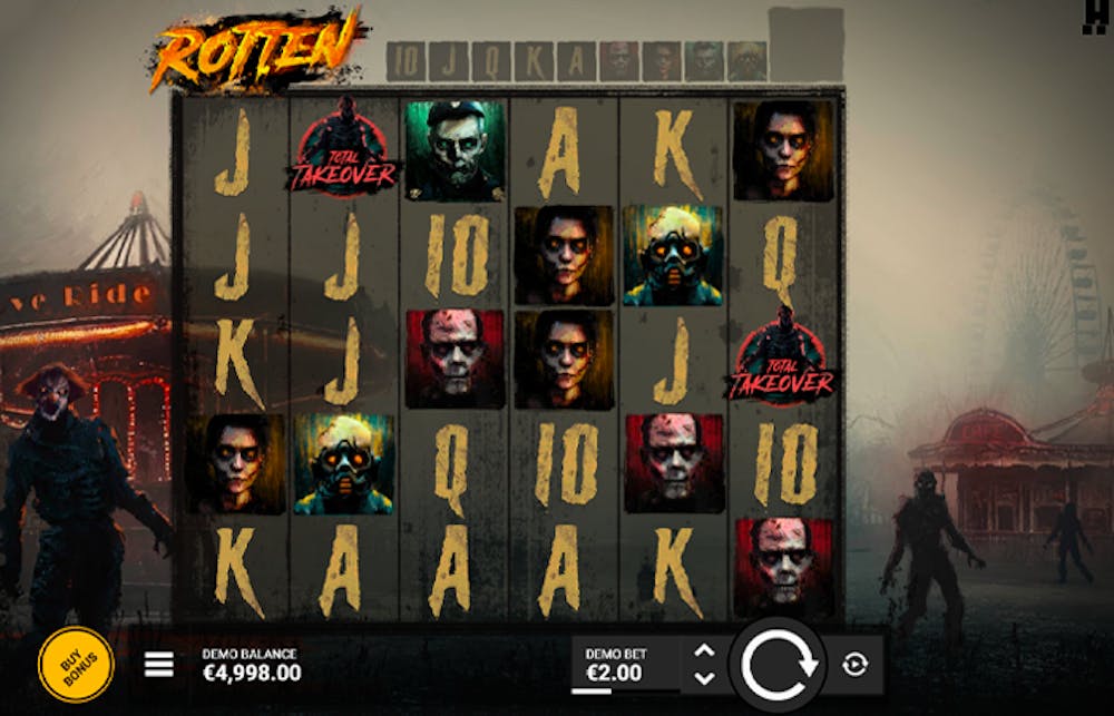 Rotten slot game interface showing a creepy, post-apocalyptic carnival theme with dim lighting and eerie fog. The reels display zombie characters, glowing 'Wild' symbols, and distressed card values, while a menacing clown figure looms on the left side. The interface includes 'Buy Bonus' and bet options at the bottom.